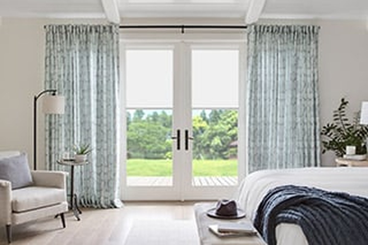 Patterned panel drapery in a modern living room by Budget Blinds