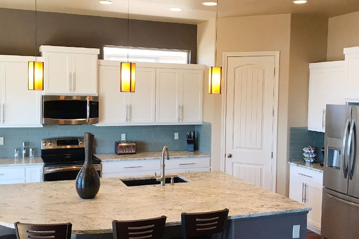 Before and after of a kitchen cabinet refacing project by Kitchen Tune-Up